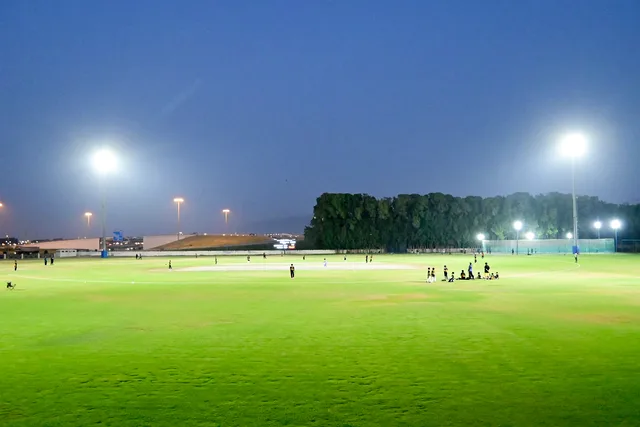 SES cricket ground illuminated by floodlights for evening play